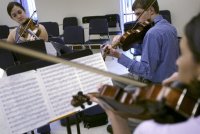 (left to right clockwise) Liz Benoit-Crew, on violin, Ryan Stauffer, on violin, and Yank'l Garcia, on viola, play Friday, July 18, 2003, during practice of the Bell South Youth Ensemble at Stetson University in DeLand. (Photo: Chad Pilster)